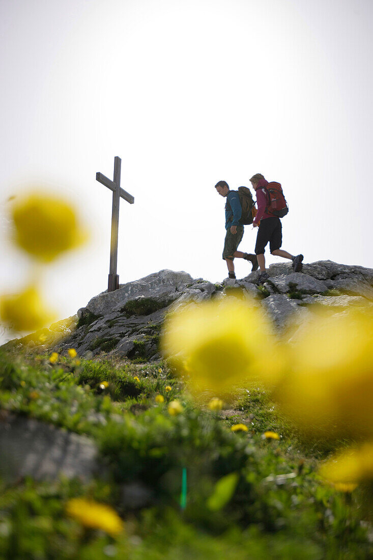 Hikers arriving summit cross, Werdenfelser Land, Bavaria, Germany