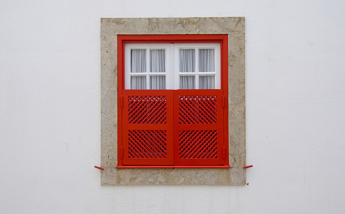 Window with red window shutters, Historical, old fishing village of Ericeira, Portugal