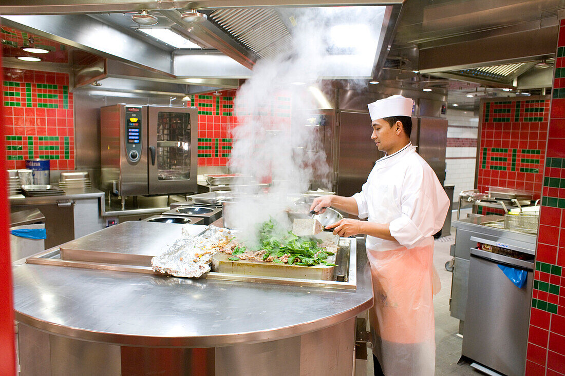 A cook working in the kitchen of cruise ship AidaDiva
