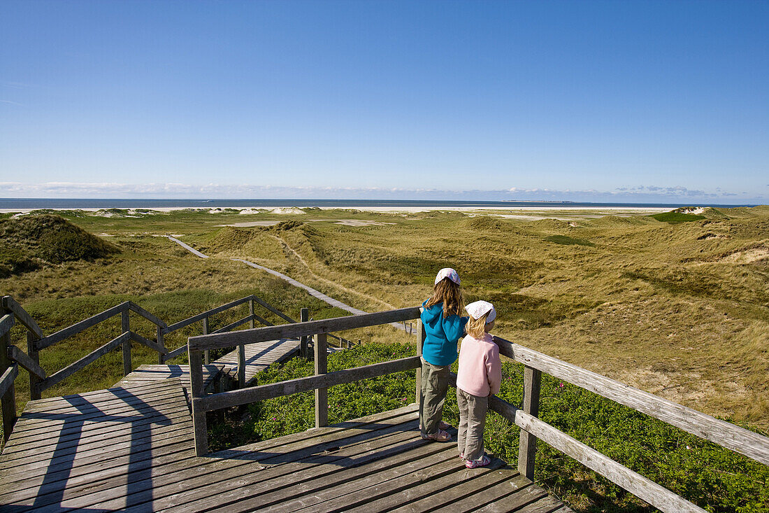 Children looking over dunes to North Sea, Amrum island, Schleswig-Holstein, Germany