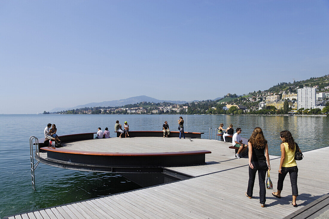 People sitting along the promenade at Lake Geneva, Montreux, Canton of Vaud, Switzerland