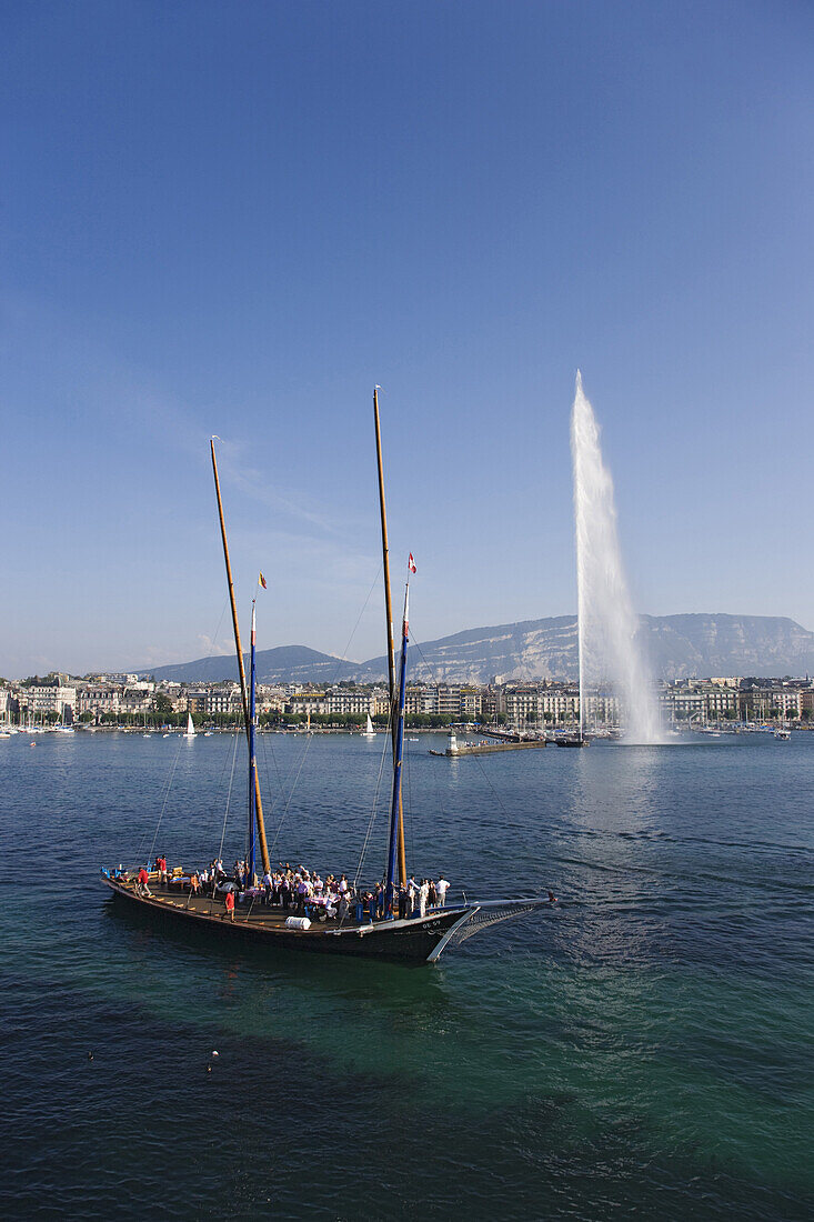 Traditional cargo sailer and Jet d'Eau, one of the largest fountains in the world, Lake Geneva, Geneva, Canton of Geneva, Switzerland
