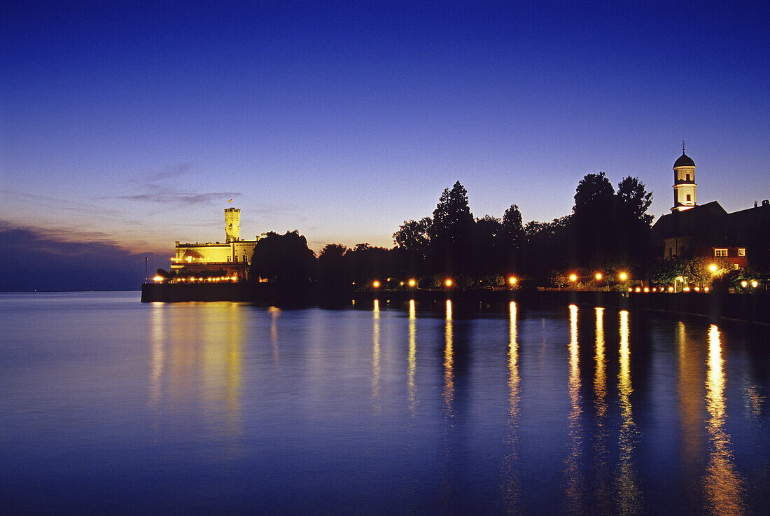 The illuminated Monfort castle at the lakeshore in the evening, Lake Constance, Baden Wurttemberg, Germany