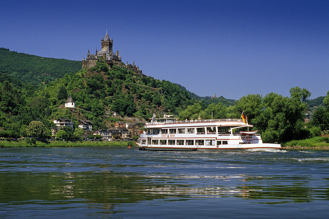 Excursion boat on river Moselle, Reichsburg in background, Cochem, Rhineland-Palatinate, Germany