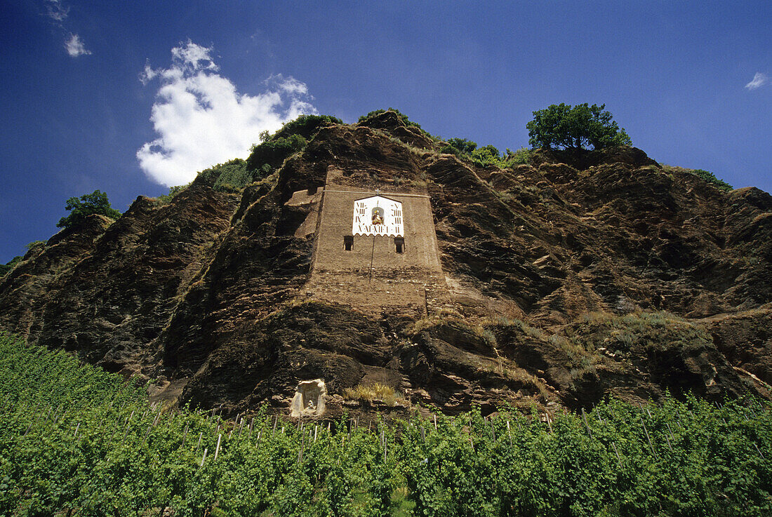 Sundial at a rock above vines, Mosel, Rhineland-Palatinate, Germany