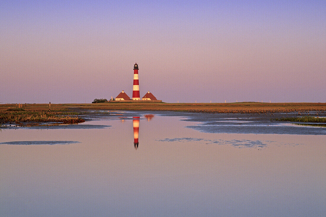 Westerhever lighthouse near St. Peter-Ording, reflection in the tideland, Eiderstedt peninsula, North Friesland, North Sea, Schleswig-Holstein, Germany