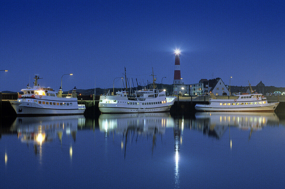 Ships in harbor, lighthouse in background, Hornum, Sylt island, Schleswig-Holstein, Germany