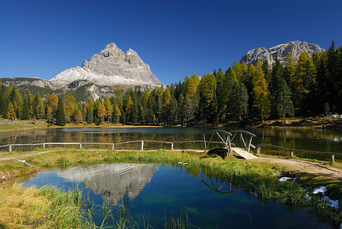 Drei Zinnen above lake Antornosee with path with bridge, Dolomites, South Tyrol, Italy