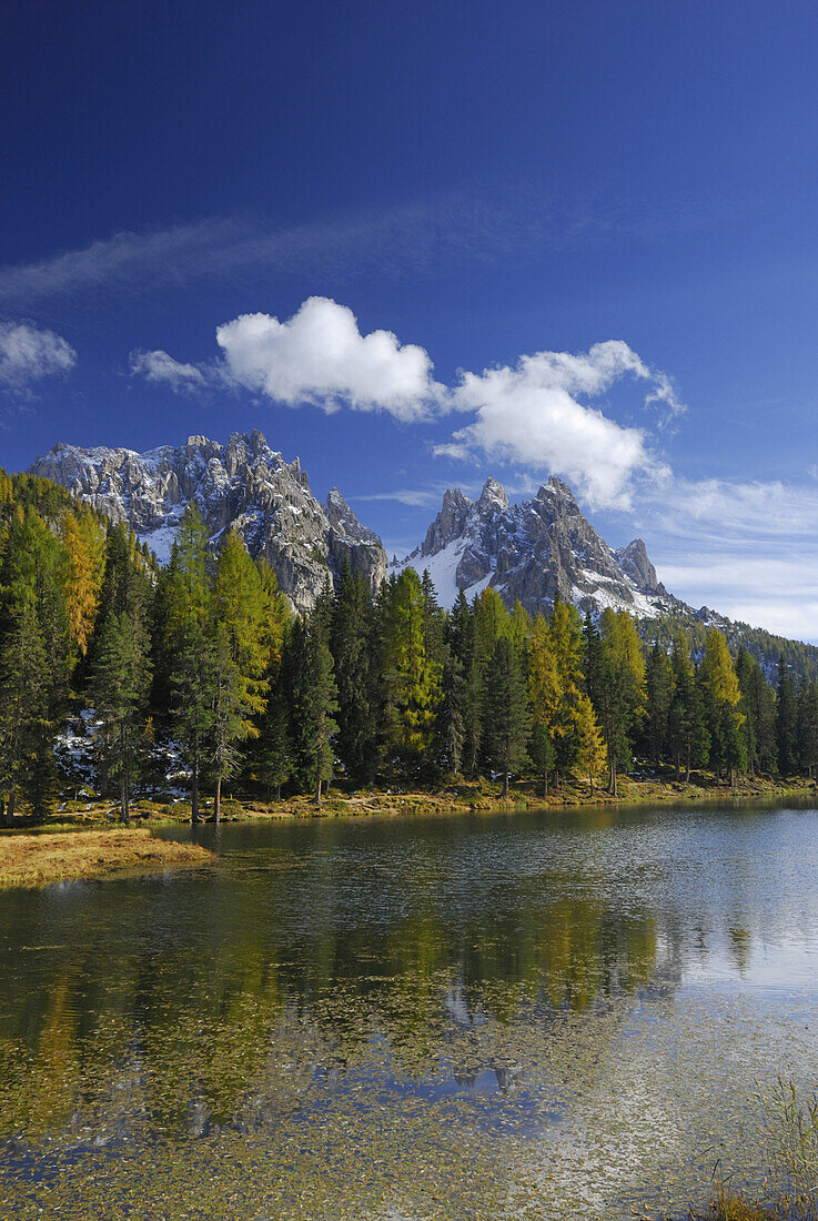Cadini range above lake Antornosee with larches in autumn colors, Dolomites, South Tyrol, Italy