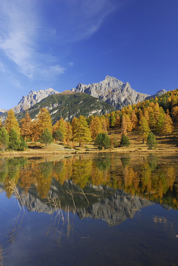 View over a lake to Piz Lischana and Piz San Jon, Lower Engadin, Engadin, Grisons, Switzerland