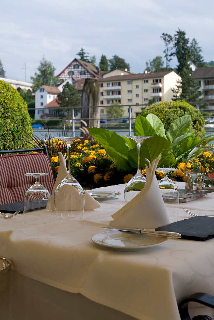 Ready laid table with table settings on the terrace of Restaurant Hotel Fischerzunft, Rhine, Schaffhausen, Switzerland