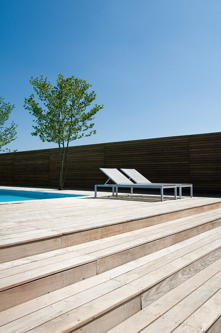 Sunloungers at the terrace next to the pool under blue sky, Hotel Riva, Constance, Lake Constance, Baden-Wurttemberg, Germany