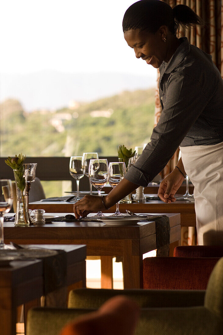 A man laying the table in a restaurant, Forest Lodge, Gansbaai, South Africa, Africa