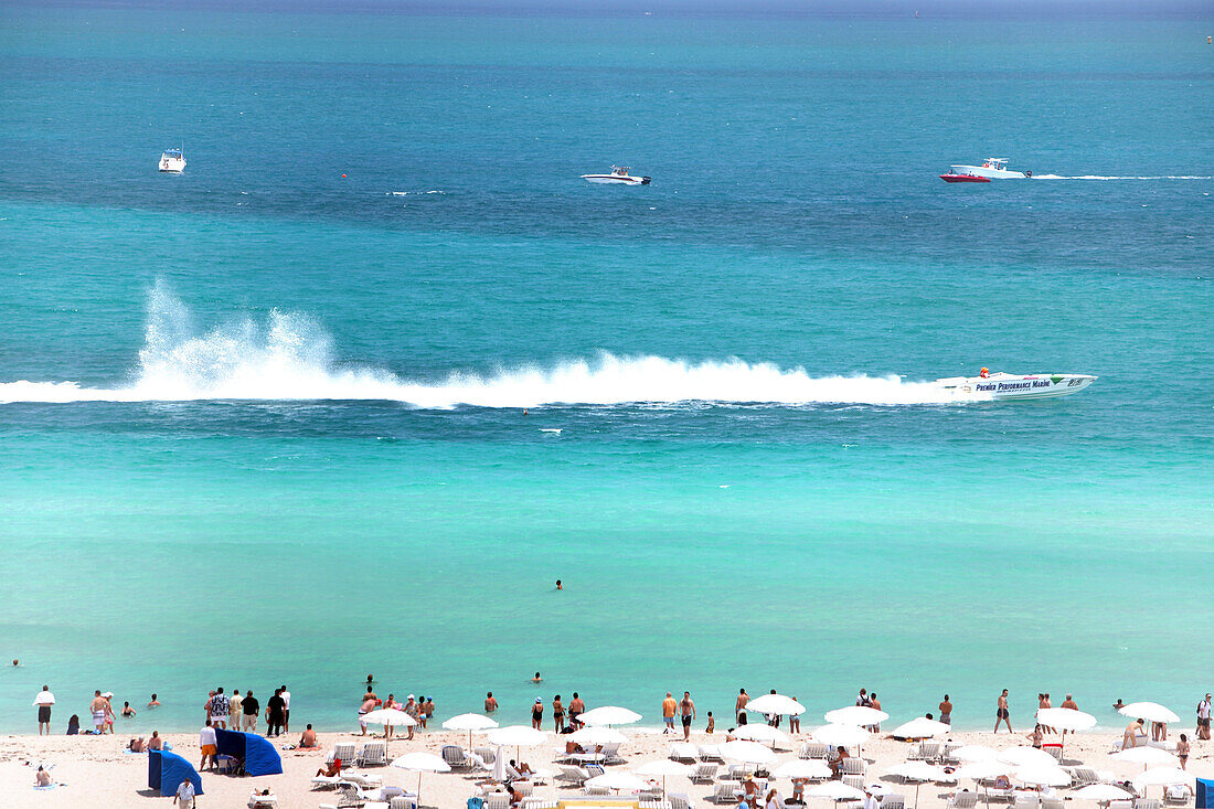 People on the beach watching a motor boat racing, South Beach, Miami Beach, Florida, USA