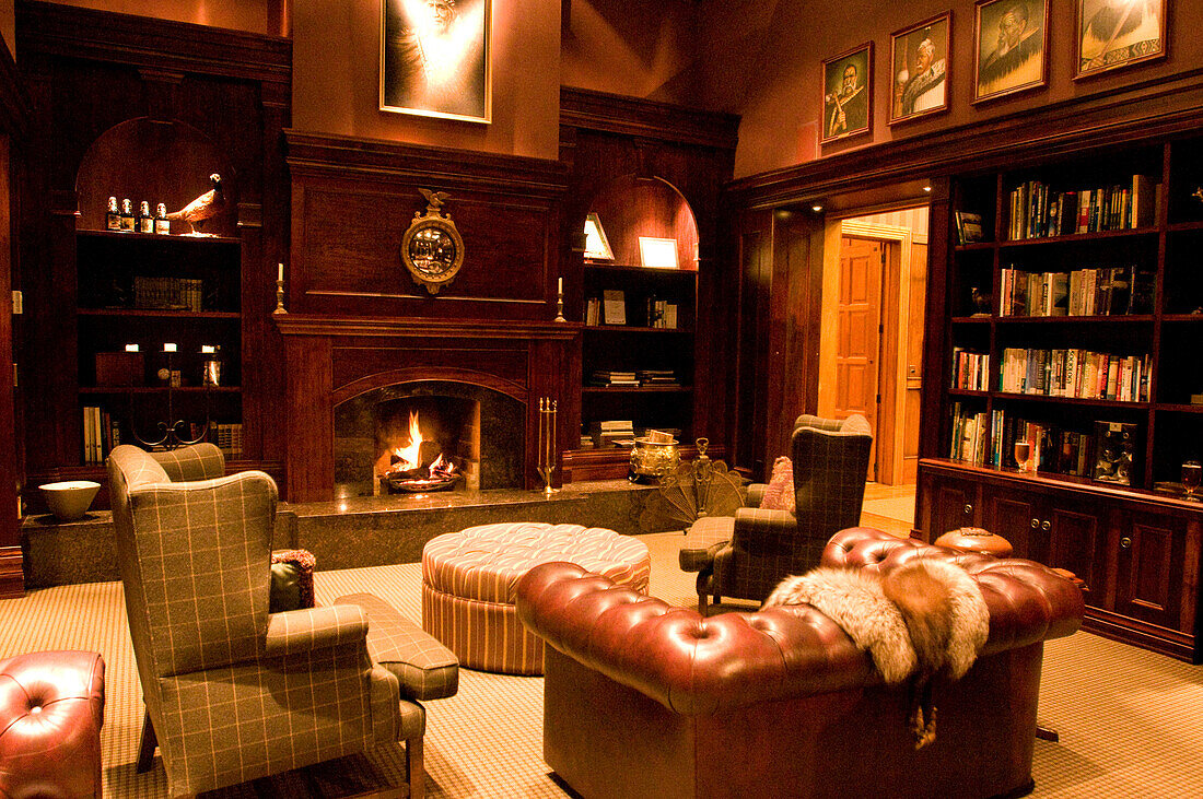 Cosy armchairs standing by the fireside at the Treetops Lodge, North Island, New Zealand, Oceania