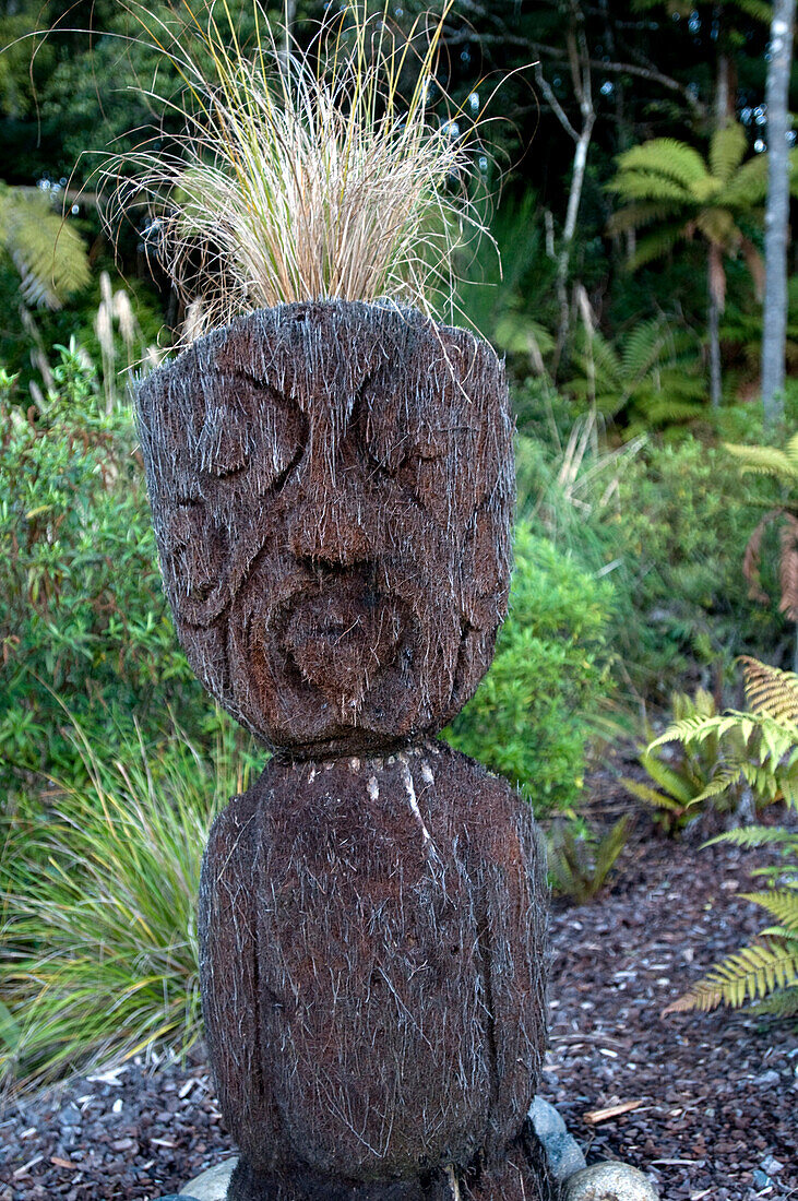 Carved figure at the garden of the Treetops Lodge, North Island, New Zealand, Oceania