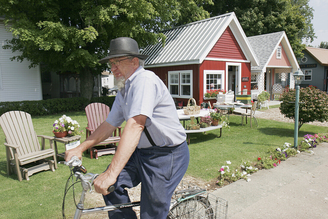 Courtyard of Arts, Amish man, bicycle. Shipshewana. Indiana. USA.