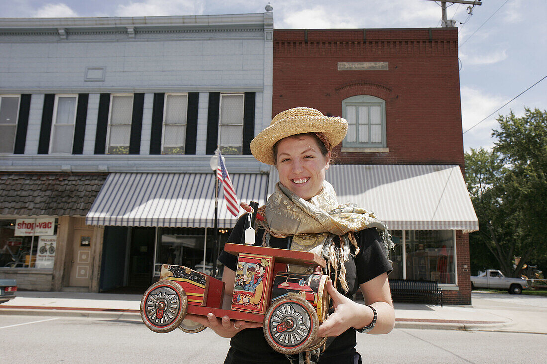 Yoder Brothers Antiques, woman, toy truck. Elkhart Street. Wakarusa. Indiana. USA.