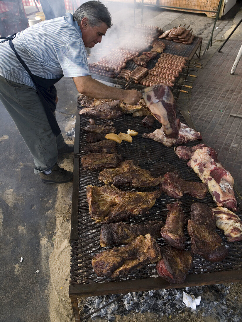 Workers cook beef in street at dance festival in Buenos Aires, Argentina