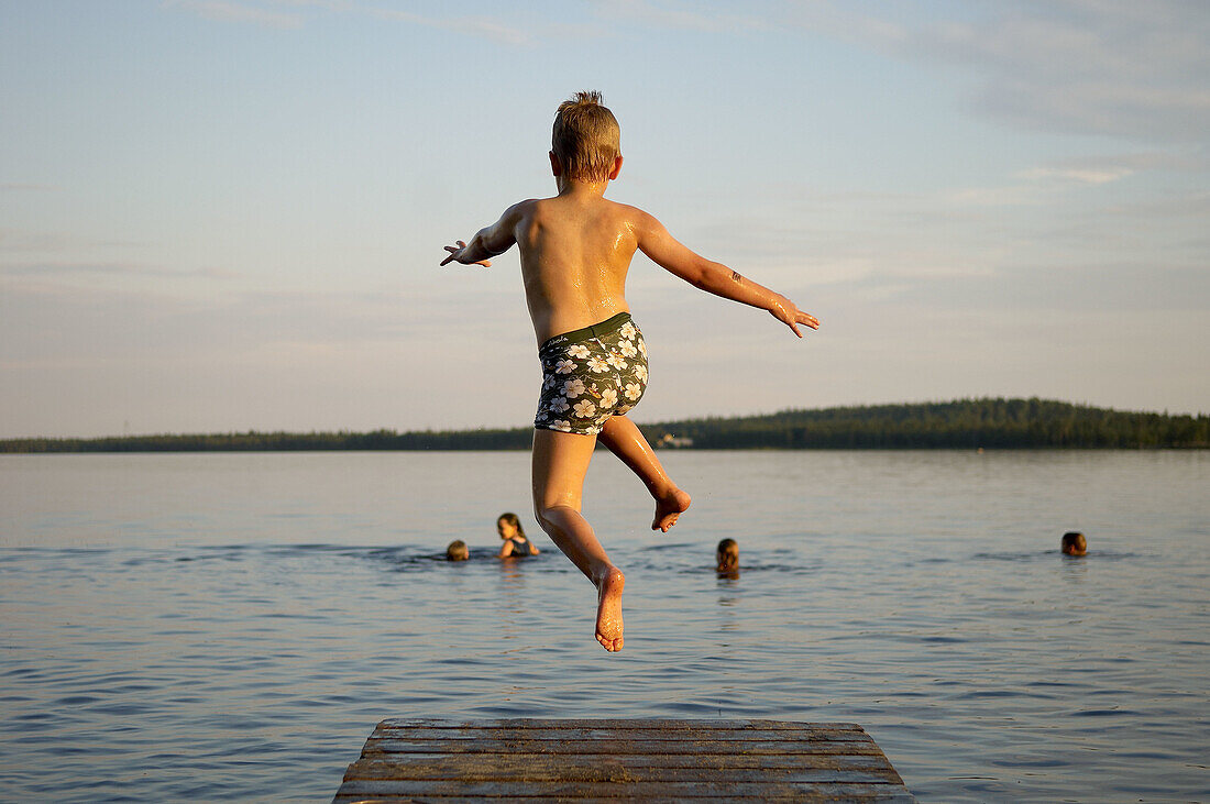 7 year old boy and jumping from a jetty, Norrbotten, Sweden (July 2005)