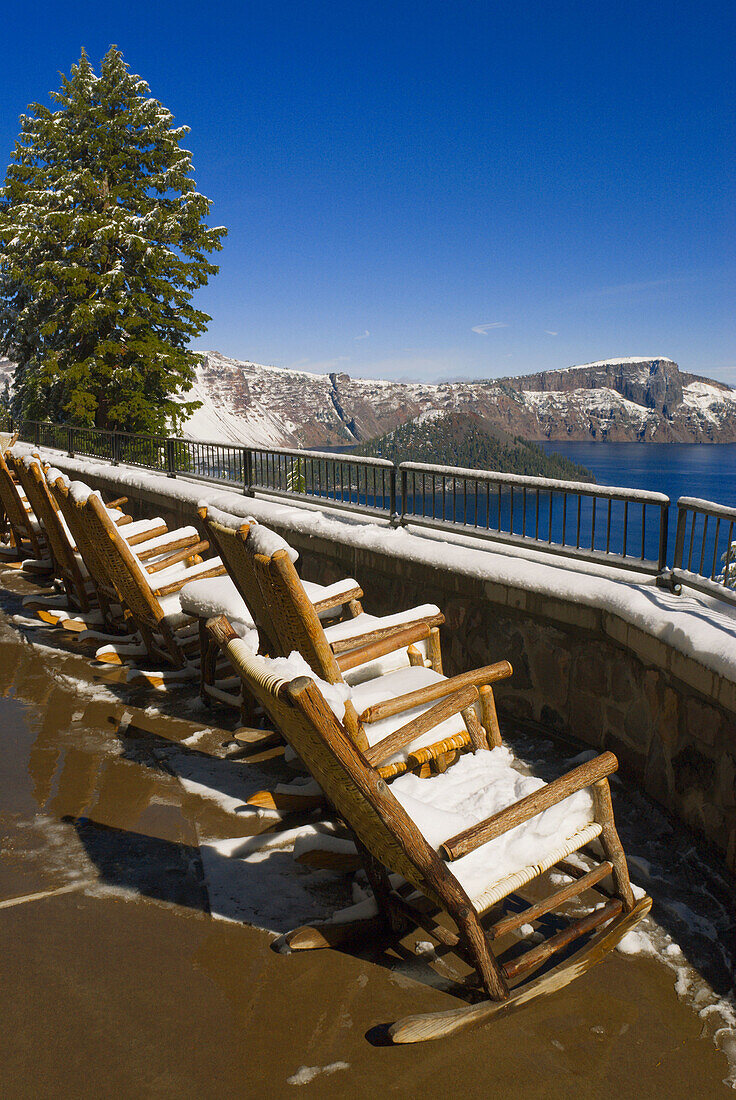 Snow covered chairs at Crater Lake Lodge, Crater Lake National Park, Oregon, USA