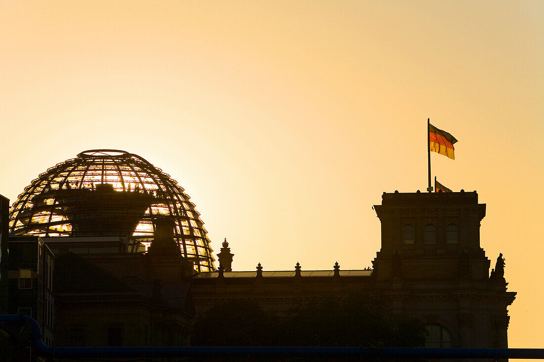 silhouette of German parliament, Reichstag dome at sunset, Berlin, Germany