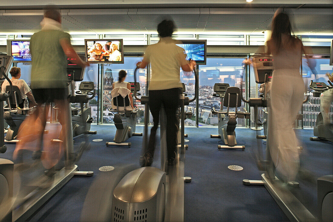 People exercising at the gym Skyclub at highrise building Neues Kranzler Eck, Berlin, Germany, Europe