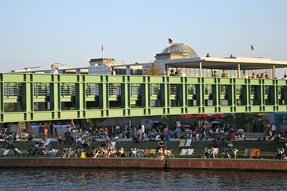 People at the bank of the river Spree and on Gustav Heinemann bridge, Berlin, Germany, Europe