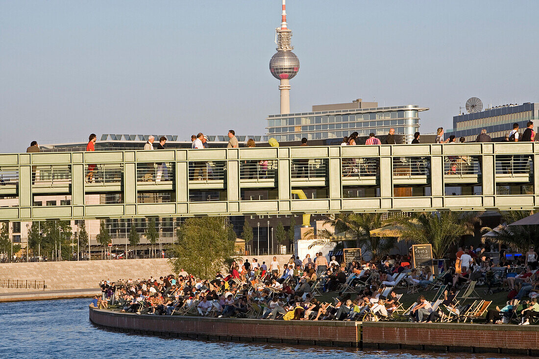 People at the bank of the river Spree and on Gustav-Heinemann bridge, Berlin, Germany, Europe