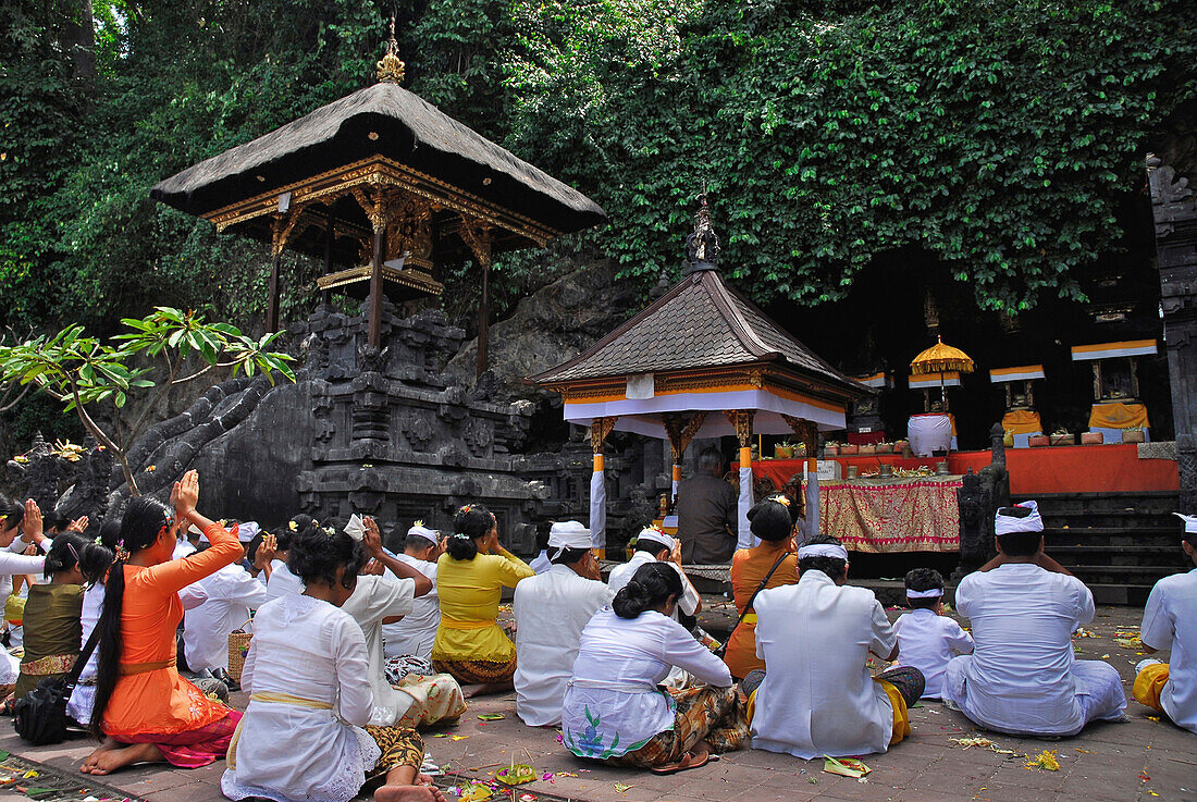 Praying pilgrims in front of a temple, Goa Lawah, East Bali, Indonesia, Asia