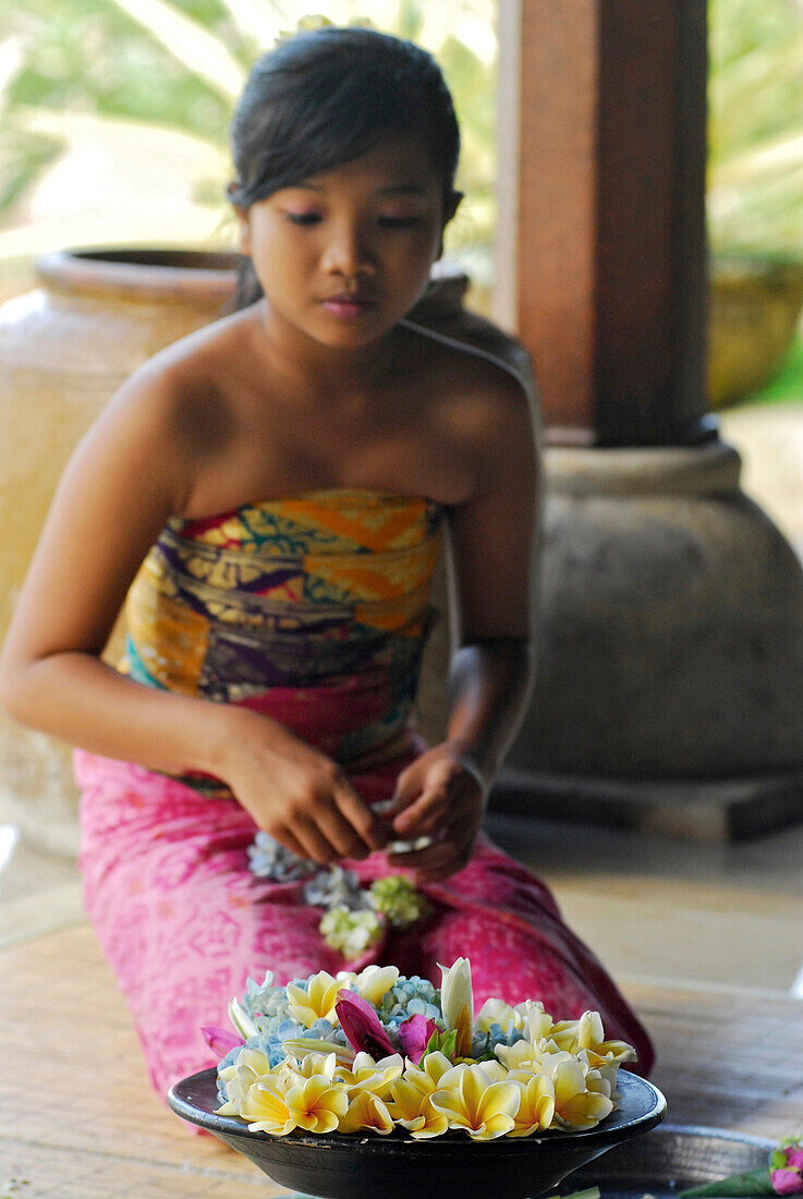 Girl with floral wreaths at the lobby of Four Seasons Resort, Jimbaran, Bali, Indonesia, Asia