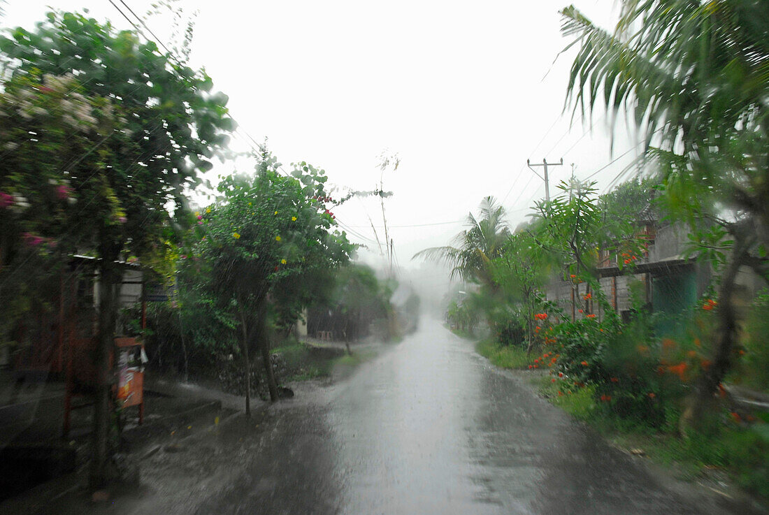 Empty village street in the rain, North Bali, Indonesia, Asia