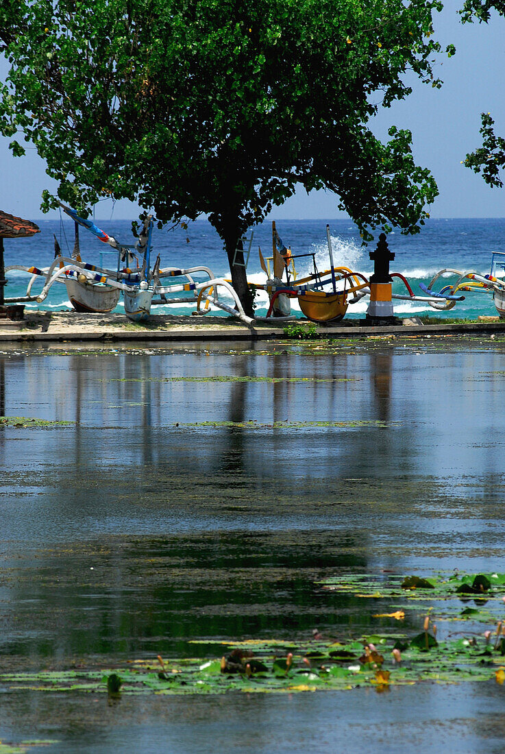 Pond at Candi Dasa with boats on the shore, Candi Dasa, Bali, Indonesia, Asia