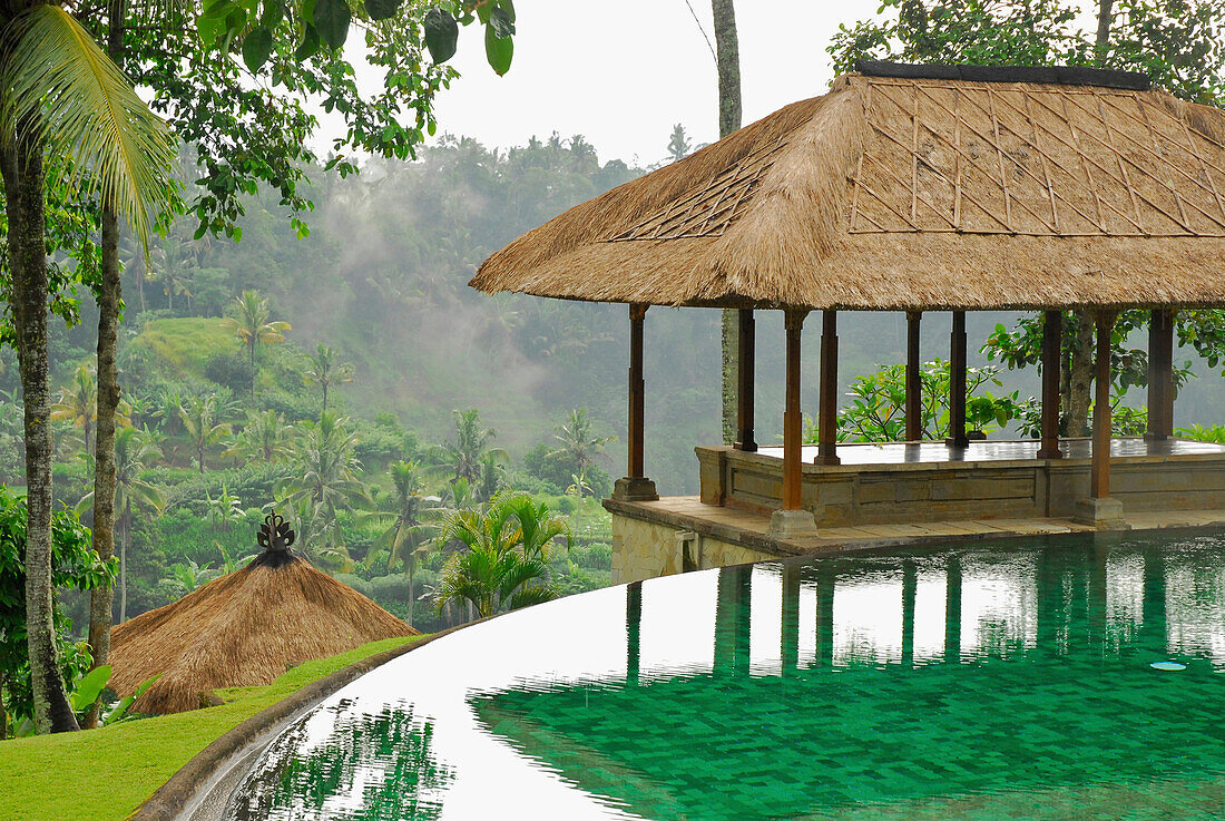The pool and pavilions of the Amandari Resort in the rain, Yeh Agung valley, Bali, Indonesia, Asia