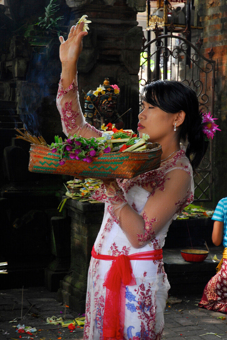 Frau bringt Opfergaben in einen Tempel, Ubud, Zentral Bali, Indonesien, Asien