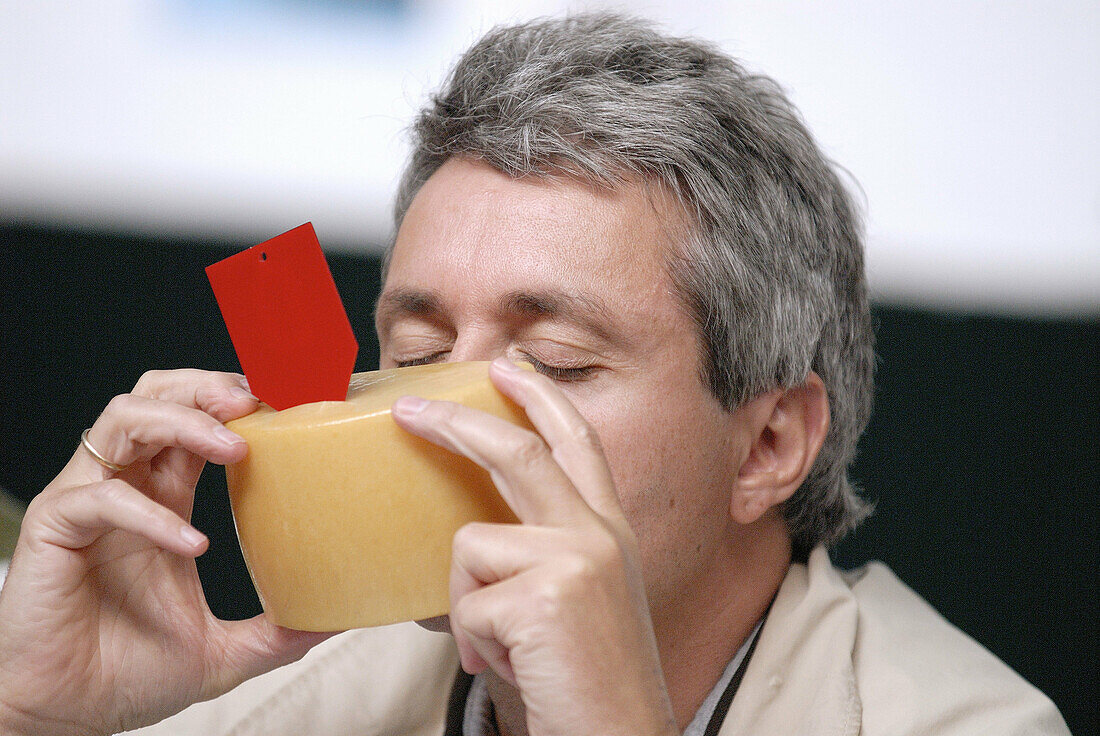 Judge tasting cheese in a cheese contest. Euskadi. Spain.