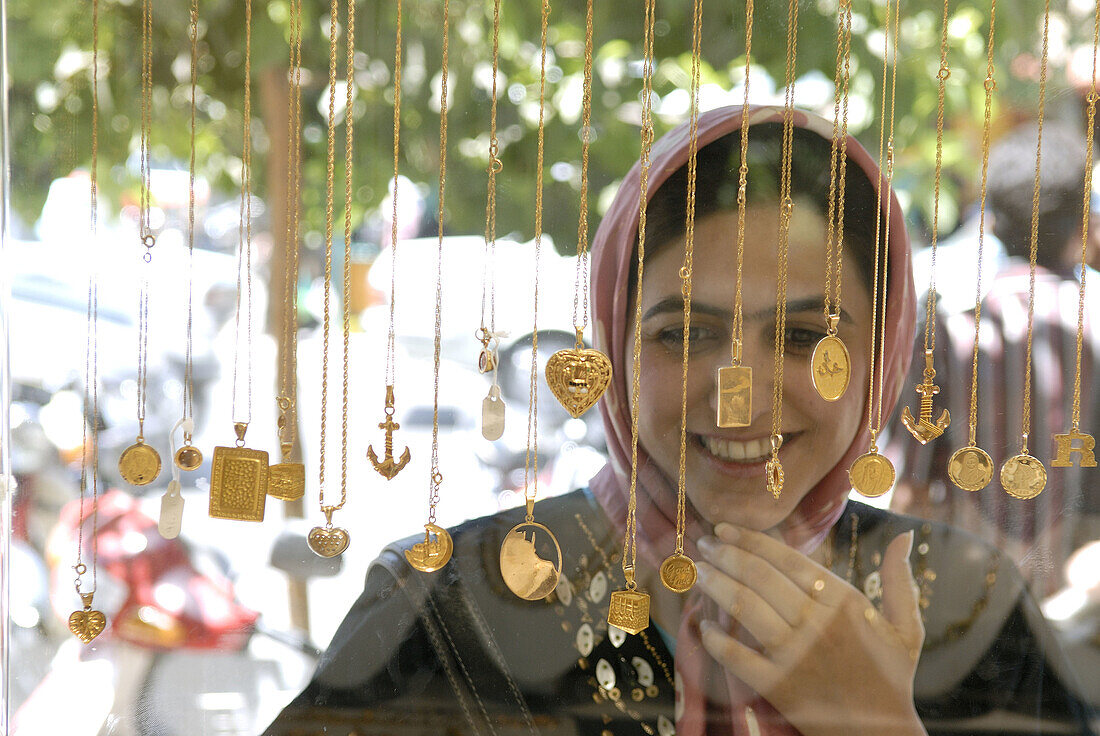 Iranian woman looking at shop window. Esfahan, Iran