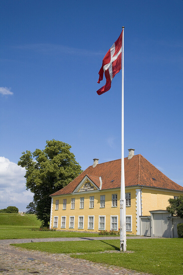 Commandant's quarters and the Danish national flag (Dannebrog). Kastellet, one of the best preserved fortifications in Northern Europe. Copenhaguen. Denmark.