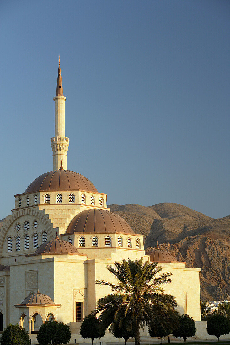 A mosque in the twilight with the Eastern Hajars mountain range in the background, Muscat, Oman, Arabia, Middle East, Asia