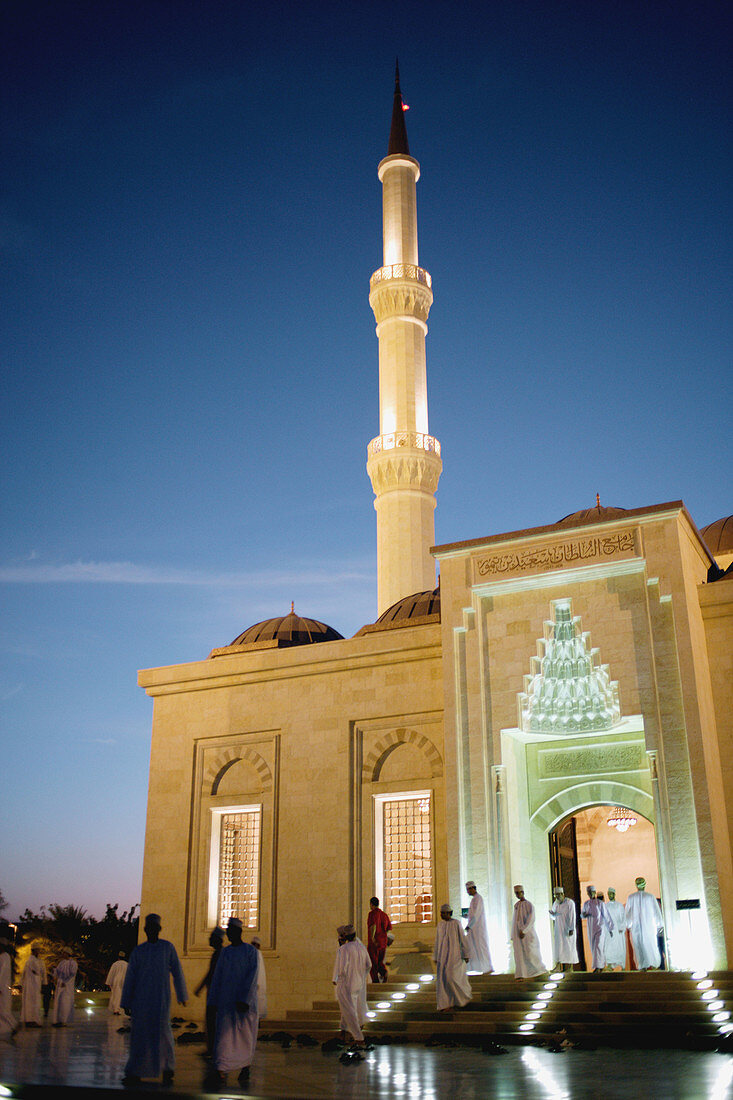 Omani moslems coming out of a mosque after the traditional evening prayer being dressed in their jilbab, the - mostly - white traditional flowing robe, Muscat, Oman, Arabia, Middle East, Asia