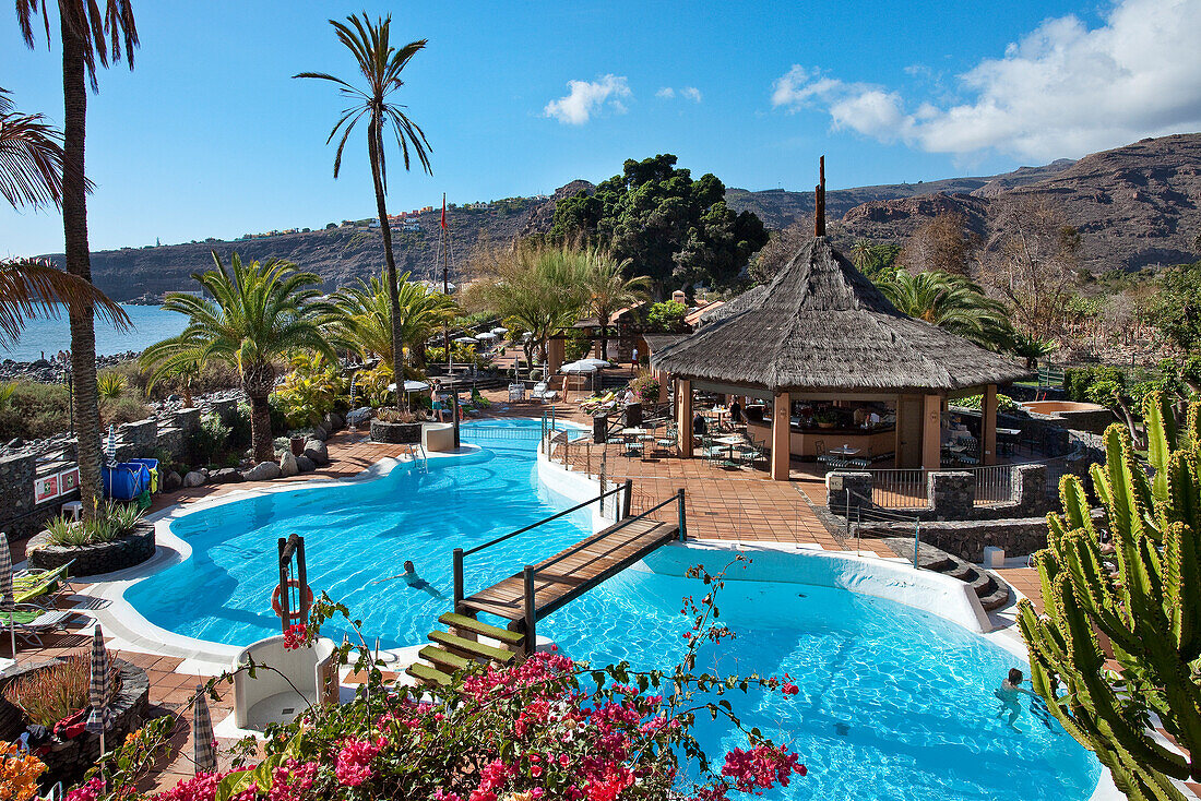 View over the swimming pool of Jardin Tecina Hotel in the sunlight, Playa de Santiago, La Gomera, Canary Islands, Spain, Europe