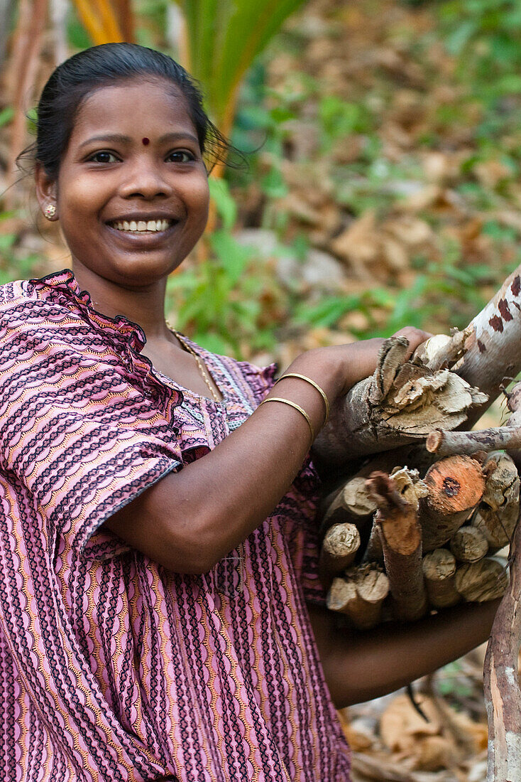 woman collecting firewood, Havelock island, Andaman Islands, India