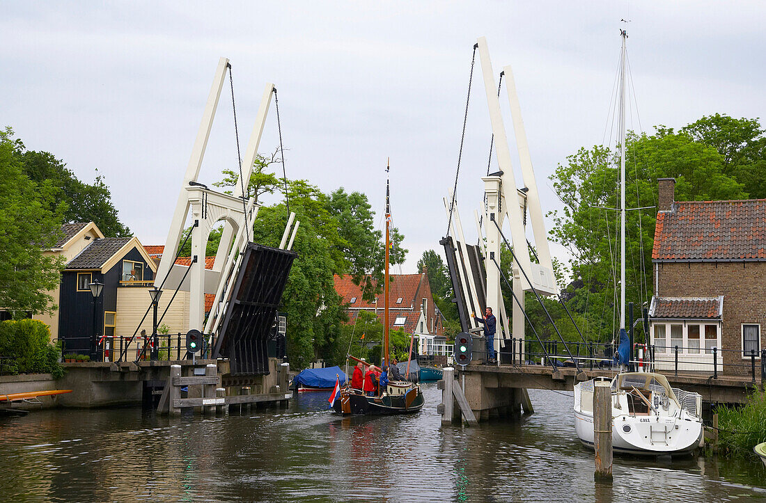 Ein Segelboot auf dem Fluss Vecht fährt an einer Klappbrücke vorbei, Holland, Europa