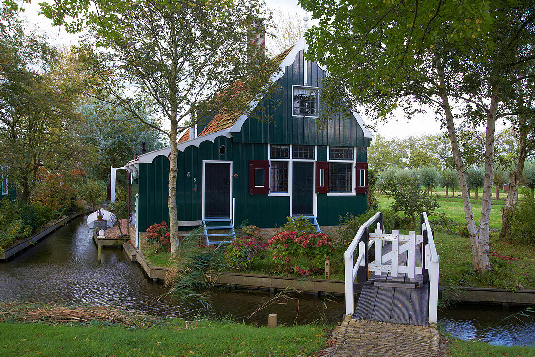 View at a house under trees at a canal, Open-air museum Zaanseschans, Netherlands, Europe