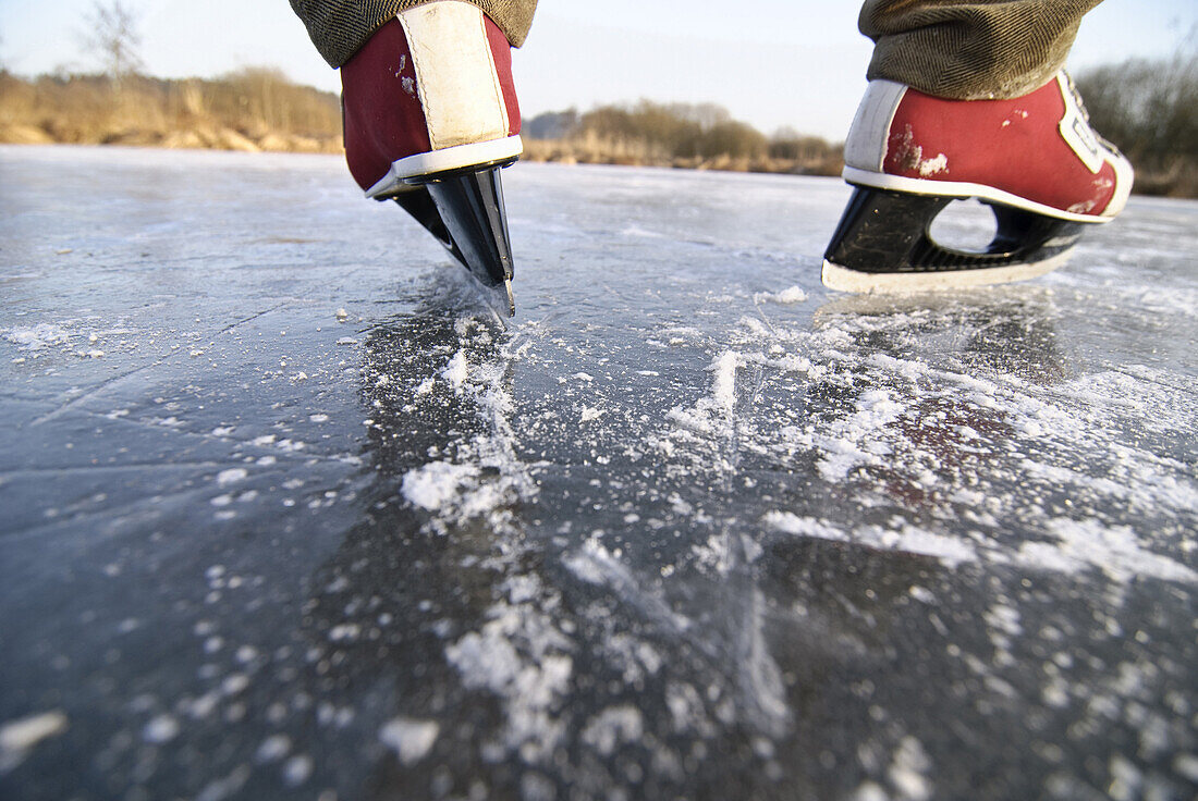 Man skating on lake Ammersee, Upper Bavaria, Germany