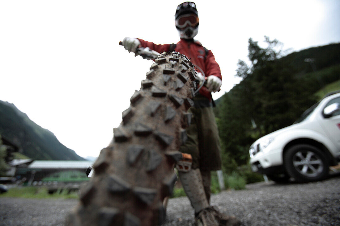 Man holding his mountainbike, Ischgl, Tyrol, Austria