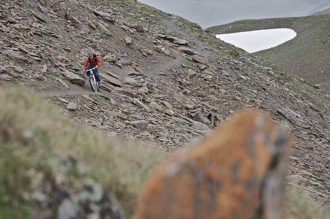 Mountainbiker riding on a trail in the mountains, Ischgl, Tyrol, Austria