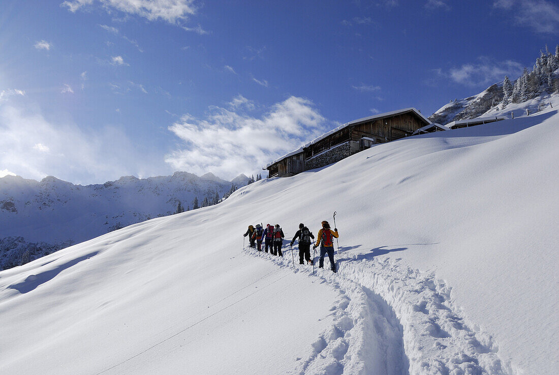Backcounty skiiers ascending to alpine hut, Wiedersberger Horn, Kitzbuehel range, Tyrol, Austria