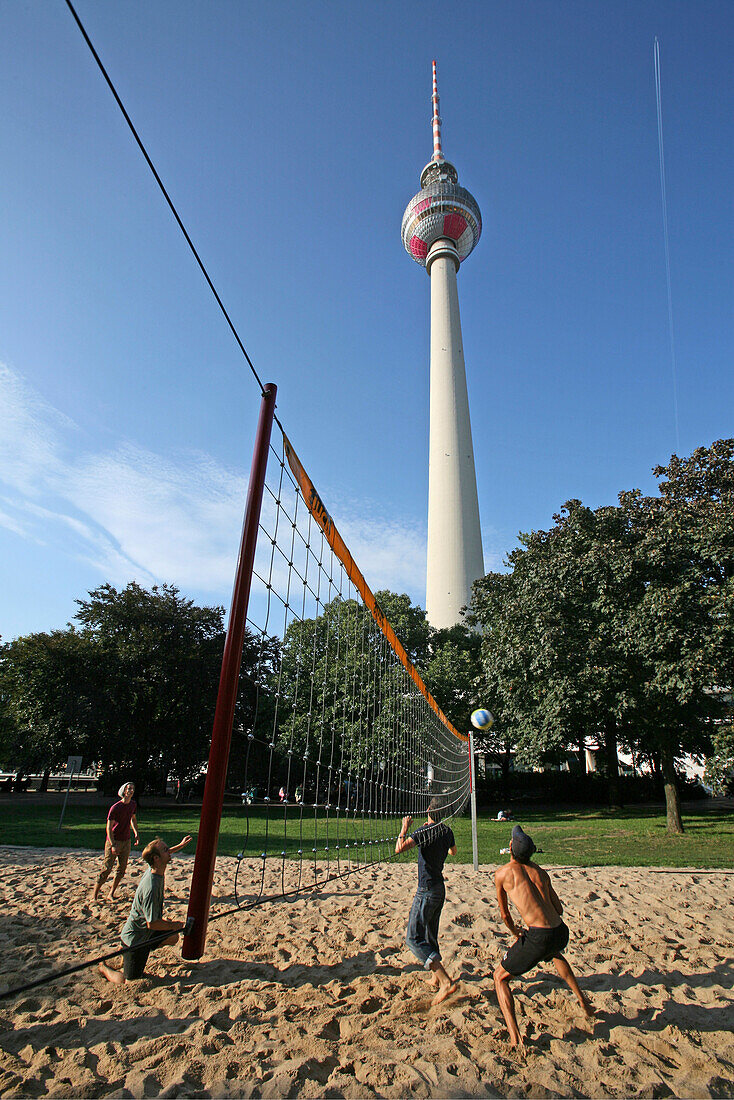 volleyball game below television tower near Alexanderplatz, Berlin, capital, Germany