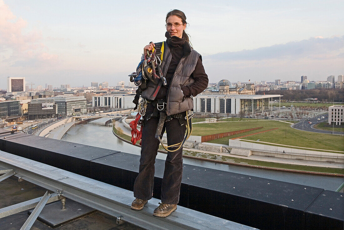 woman roof worker with equipment on central railway station, Berlin